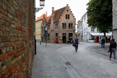 Bruges, Belgium - September 9, 2022: Historic brick architecture at the intersection of cobbled streets