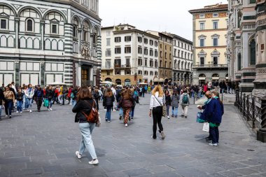 Floransa, İtalya - 13 Nisan 2023: Birçok kişi Floransa Vaftizhanesi ile Duomo Floransa Katedrali arasındaki Katedral Meydanı 'nda yürüyor. Turistler tarafından en çok ziyaret edilen yerlerden biri.