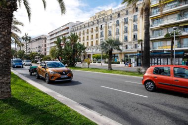 Nice, Fransa - 24 Nisan 2023: Deniz kıyısındaki Promenade des Anglais sadece bir şehir sokağı değil, aynı zamanda bisiklet ve yayalar için de bir yoldur. Denize bakan binalar var.