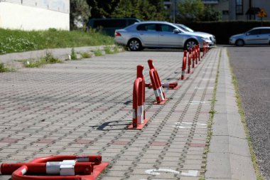 Varşova 'daki Goclaw arazisindeki özel park yerini işaretlemek ve korumak için park yerine metal, katlanabilir ve kilitlenebilir beyaz ve kırmızı çelik boru bariyerleri yerleştirildi.