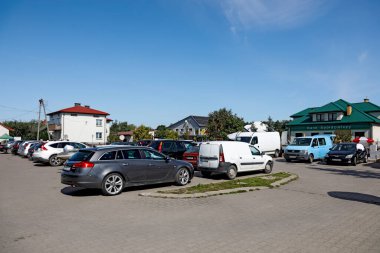 Wilga, Poland  August 12, 2023: There are a lot of cars in a car park in a village in the Mazowieckie Voivodeship, in the district of Garwolin. The origins of this town date back to the thirteenth century. clipart
