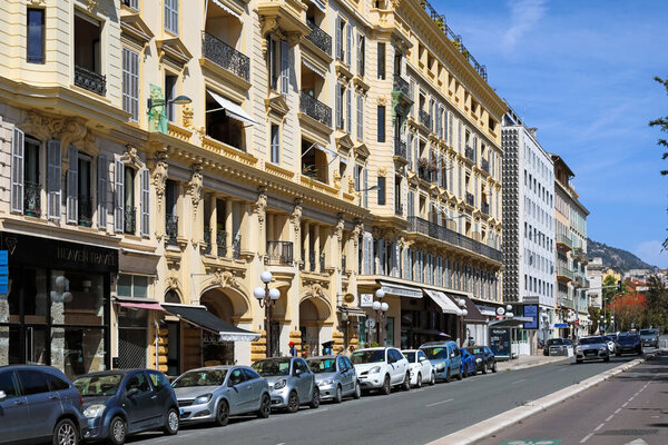 Nice, France - April 25, 2023: Mediterranean architecture of buildings along the street where cars are parked