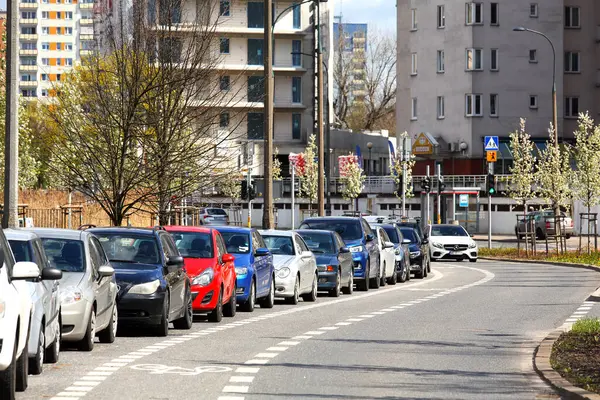 stock image Warsaw, Poland - April 6, 2024: Cars are parked one behind the other. This row of cars on the side of the road can be seen in Goclaw, a sub-district of Praga-Poludnie.