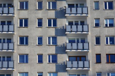 Warsaw, Poland - January 8, 2024: Part of the facade with balconies of a large block of flats, lit by the sun on a sunny day in the Goclaw area of the Praga-Poludnie district.