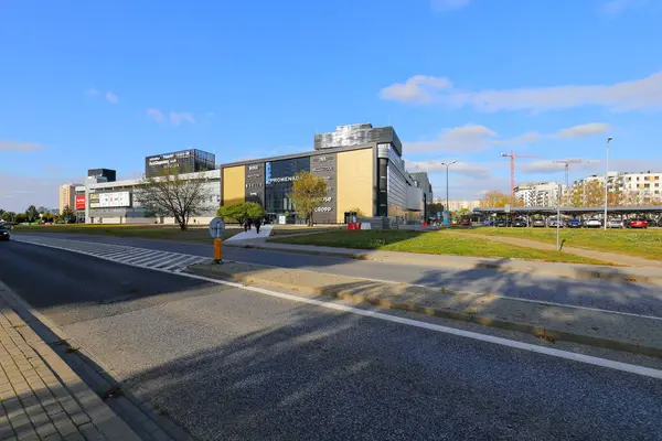 stock image Warsaw, Poland - October 18, 2023: A view of the distant modern shopping centre known as the Promenada, housed in a large building visible across the road in the Goclaw housing estate.