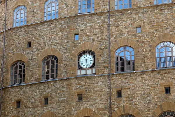 stock image Florence, Italy - April 16, 2023: Clock on the stone facade of the historic building that houses the Museo Salvatore Ferragamo in Piazza Santa Trinita