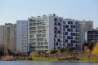 Warsaw, Poland - March 7, 2024: Modern block of flats in a snowless winter in the Goclaw housing estate in the Praga-Poludnie district. clipart