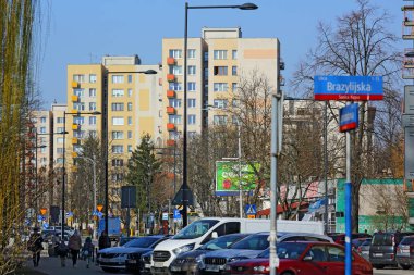 Warsaw, Poland - March 9, 2024: Blocks of flats in a snowless, sunny winter at the intersection of Brazylijska and Miedzynarodowa streets in the Saska Kepa subdivision of the Praga-Poludnie district. clipart