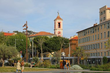 Nice, France - April 22, 2023: General view from the Promenade du Paillon towards the Old Town with the Tour de l'Horloge clock tower connected to the Palais Rusca. clipart