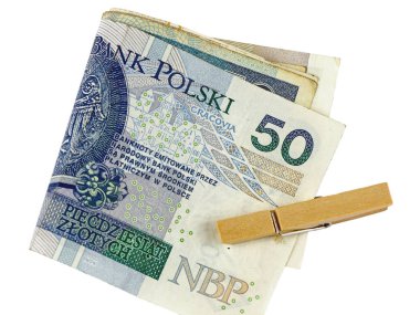 Birkaç Polonya Zloti banknotu ikiye katlandı ve bir çamaşır klipsiyle tutturuldu. Bu tema çok çeşitli finansal sorunları temsil edebilir.