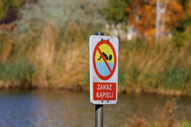 Goclaw malikanesi Varşova, Polonya 'da gölün kenarına yüzmeye izin verilmediğini belirten bir tabela yerleştirildi..