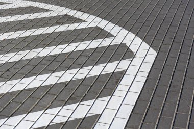 One of the methods of marking the road with white paint to exclude a certain area from vehicle traffic. A section of road marked with white parallel lines means do not park here.