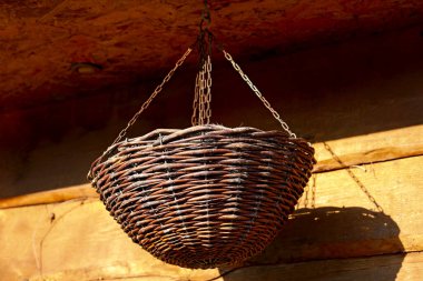 Binanın ön cephesinde zincire vurulmuş hasır sepetin görüntüsü. Ön cephe tahtadan yapılmıştır..