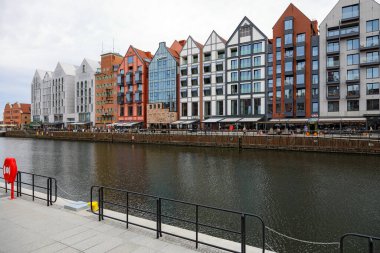 Gdansk, Polonya - 10 Ekim 2024: Geleneksel evlerin mimarisi. Renkli cepheler ve her evin biraz farklı tasarımı şehrin bu bölümündeki turistlerin ilgi odağı..