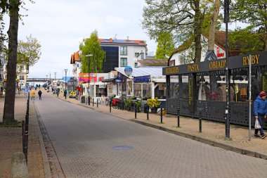 Mielno, Polonya - 15 Mayıs 2025: Bu sahil kasabasının yol kenarındaki dükkanlar, kafeler ve restoranlar da dahil olmak üzere çeşitli işletmeleri var.
