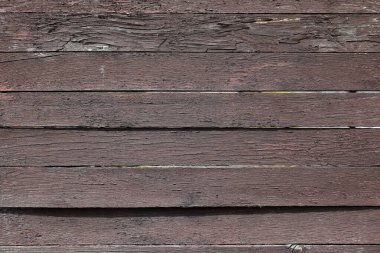 Arka plan, ahşap bir kapının kaba, tek renkli kalasları kullanılarak yapılmış, burada da görülebileceği gibi..