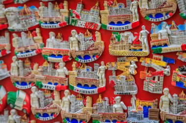 Florence, Italy - June 03, 2022: Colorful souvenir magnets with the landmarks, Duomo cathedral and the David on display at a street market gift shop
