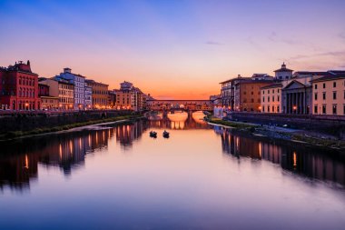 Sunset cityscape with the famous bridge of Ponte Vecchio on the river Arno River in Centro Storico, Florence, Italy