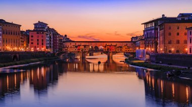 Sunset cityscape with the famous bridge of Ponte Vecchio on the river Arno River in Centro Storico, Florence, Italy
