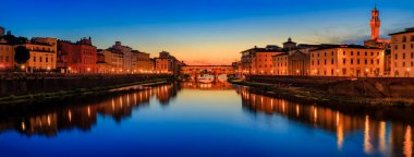 Sunset cityscape with the famous bridge of Ponte Vecchio on the river Arno River and Palazzo Vecchio in Centro Storico, Florence, Italy