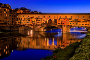 Close up of silversmith shops on the famous Ponte Vecchio bridge on the Arno River in Centro Storico, Florence, Italy at sunset