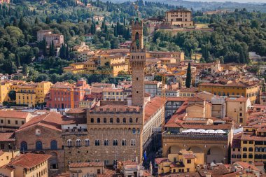 Palazzo Vecchio palace and red rooftops from Brunelleschi dome of Duomo Cathedral or Cattedrale di Santa Maria del Fiore, Florence, Italy, aerial view