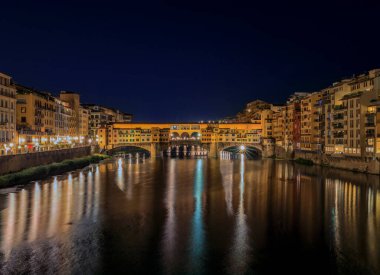 Sunset cityscape with the famous bridge of Ponte Vecchio on the river Arno River in Centro Storico, Florence, Italy