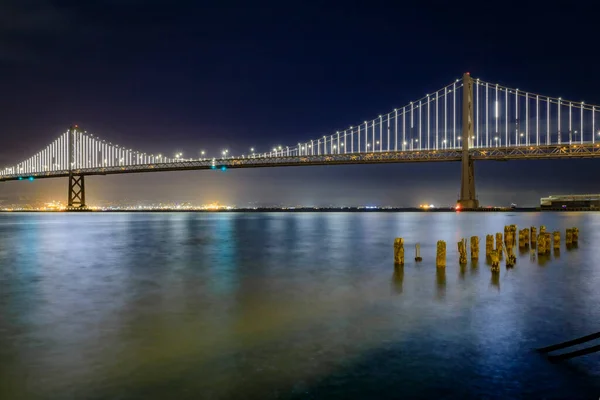San Francisco Bay Bridge Lights Night Reflecting Water Bay Long — Stock Photo, Image
