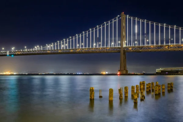 San Francisco Bay Bridge Lights Night Reflecting Water Bay Long — Stock Photo, Image