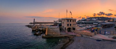 Stunning view of the Mediterranean Sea with the lighthouse in the harbor at sunset in Nice, South of France or the French Riviera