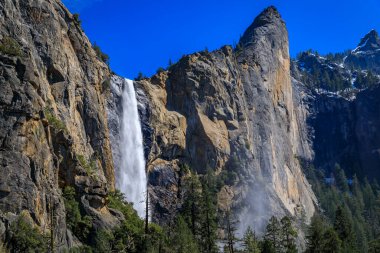Scenic view of the Bridalveil Fall in Yosemite Valley in the Yosemite National Park, Sierra Nevada mountain range in California, USA clipart