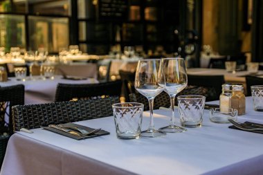 A table white table cloth at an outdoor restaurant in old town or Vieille Ville in Antibes, South of France clipart