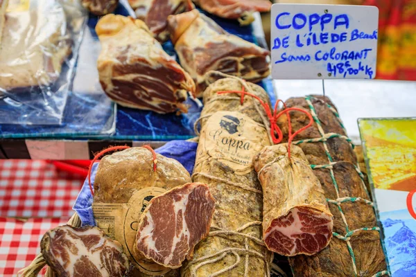 Stock image Antibes, France - May 24, 2023: Corsican coppa dry cured pork cold cut for sale on a stand at a local covered provencal farmers market in the old town