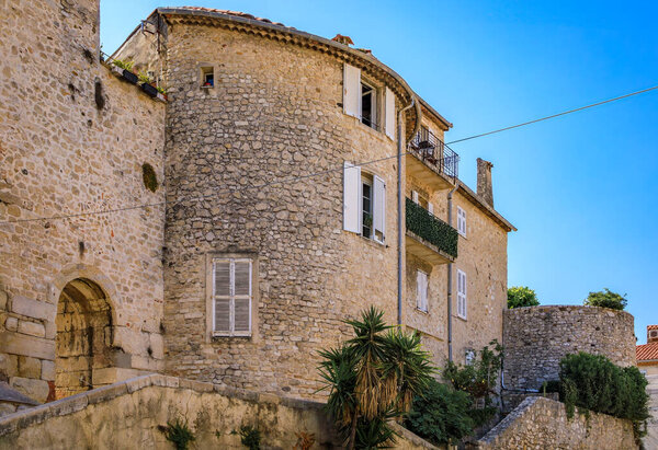 Medieval stone city walls near the local provencal farmers market in the old town or Vieil Antibes, South of France
