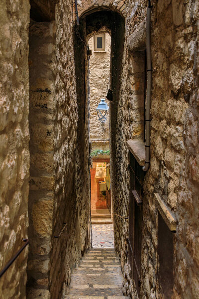 Traditional old stone houses on a narrow street in the medieval town of Saint Paul de Vence, French Riviera, South of France