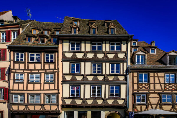 Ornate traditional half timbered houses with steep roofs in the old town of Grande Ile, the historic center of Strasbourg, Alsace, France