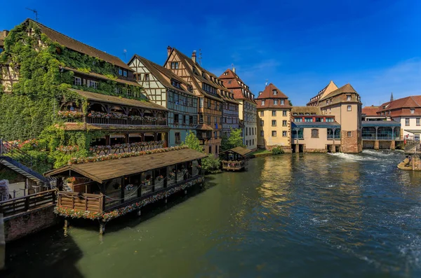 stock image Ornate traditional half timbered houses with blooming flowers along the canals in the picturesque Petite France district of Strasbourg, Alsace, France