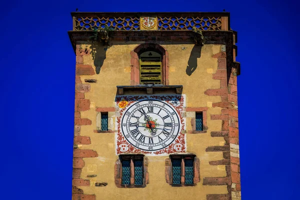 Ornate medieval clock tower with gargoyles in a popular village on the Alsatian Wine Route, in Ribeauville, France
