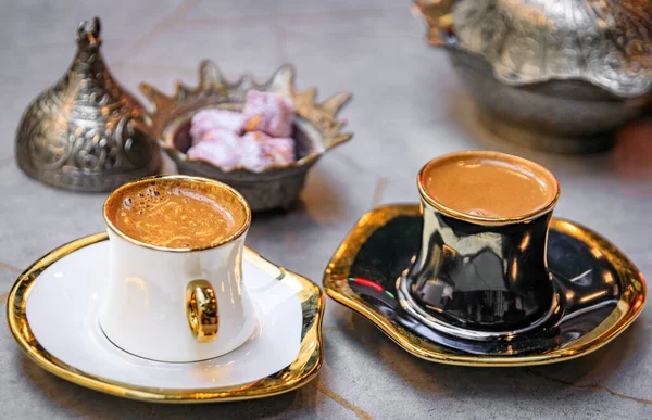 Cups of traditional Turkish coffee or turk kahvesi served with loukum or Turkish delight candy at a restaurant in Sultanahmet, Istanbul, Turkey