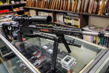 Placerville, USA - October 1, 2022: Sig Sauer Cross Precision Rifle with a scope and a bipod on display for sale at a California gun store clipart