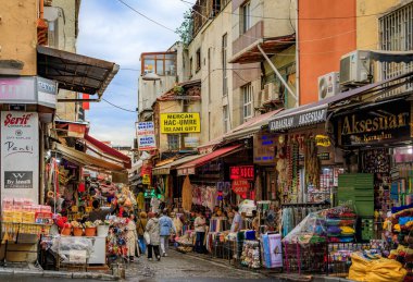 İstanbul, Türkiye - 9 Kasım 2023: Çok sayıda dükkan ve alışveriş yapan insanların yer aldığı geleneksel pazar caddesi manzarası