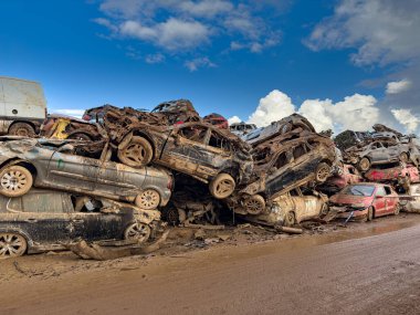 CATARROJA, VALENCIA SPAIN - DECEMBER 4 2024: After the Dana floods in Valencia Province on October 29th 2024 left massive wrecked cars, impacting countless families, claiming over 200 human lives. clipart