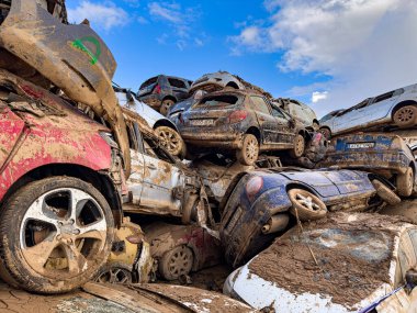 CATARROJA, VALENCIA SPAIN - DECEMBER 4 2024: After the Dana floods in Valencia Province on October 29th 2024 left massive wrecked cars, impacting countless families, claiming over 200 human lives. clipart