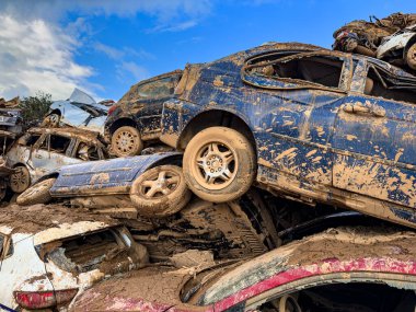 CATARROJA, VALENCIA SPAIN - DECEMBER 4 2024: After the Dana floods in Valencia Province on October 29th 2024 left massive wrecked cars, impacting countless families, claiming over 200 human lives. clipart