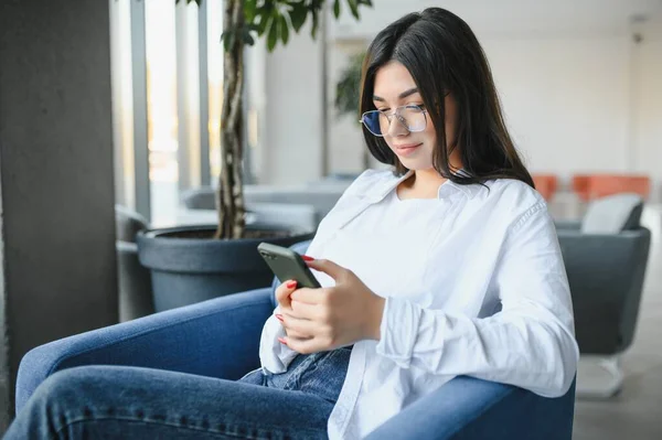 stock image Smiling girl student study online with skype teacher, happy young woman learn language listen lecture watch webinar write notes look at laptop sit in cafe, distant education.