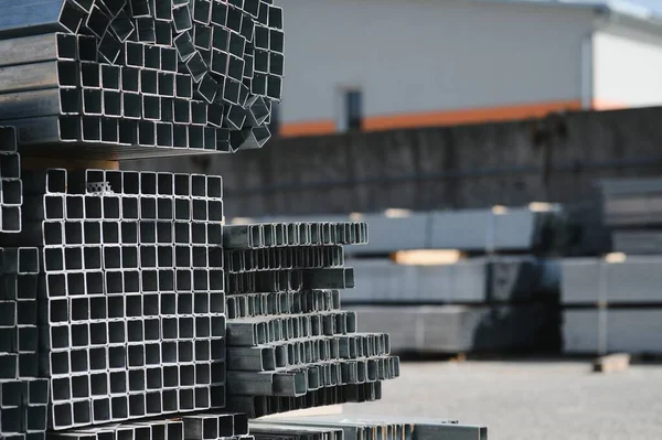 Stack of rolled metal products, perspective view of steel pipes of rectangular cross-section.