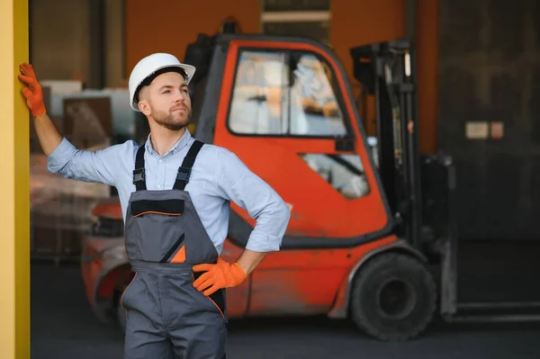 stock image Man working at warehouse and driving forklift.