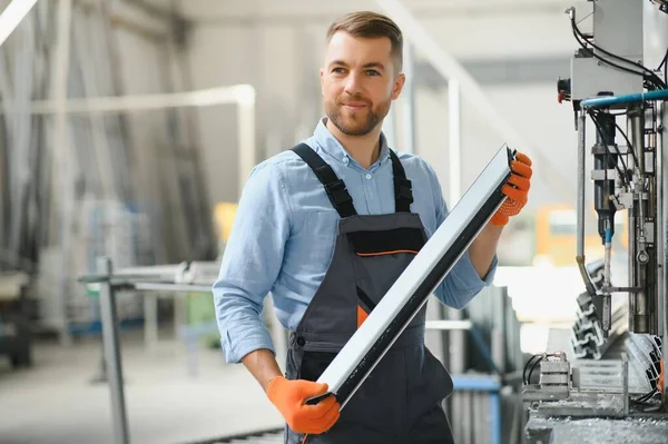 stock image Factory for aluminum and PVC windows and doors production. Manual worker assembling PVC windows and doors.