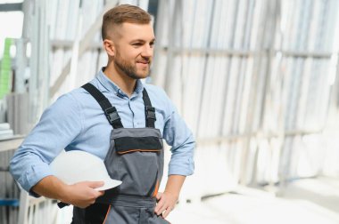 Alüminyum, PVC pencere ve kapı üretim fabrikası. PVC pencere ve kapılarını birleştiren el işçisi