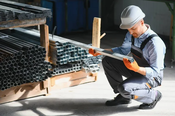 stock image Factory worker measures the metal profile.